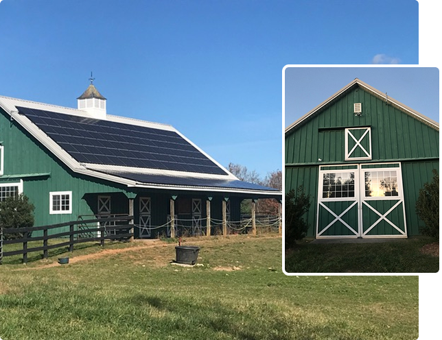 A green barn with white trim and solar panels on the roof sits in a grassy field under a clear blue sky; an inset shows a close-up of the barn’s doors.